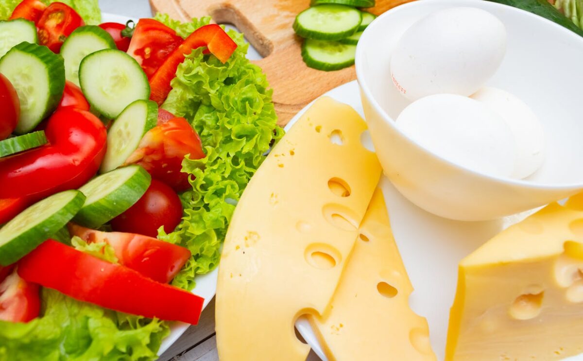 A vibrant platter of fresh salad, cheese slices, and eggs, ideal for healthy meals.
